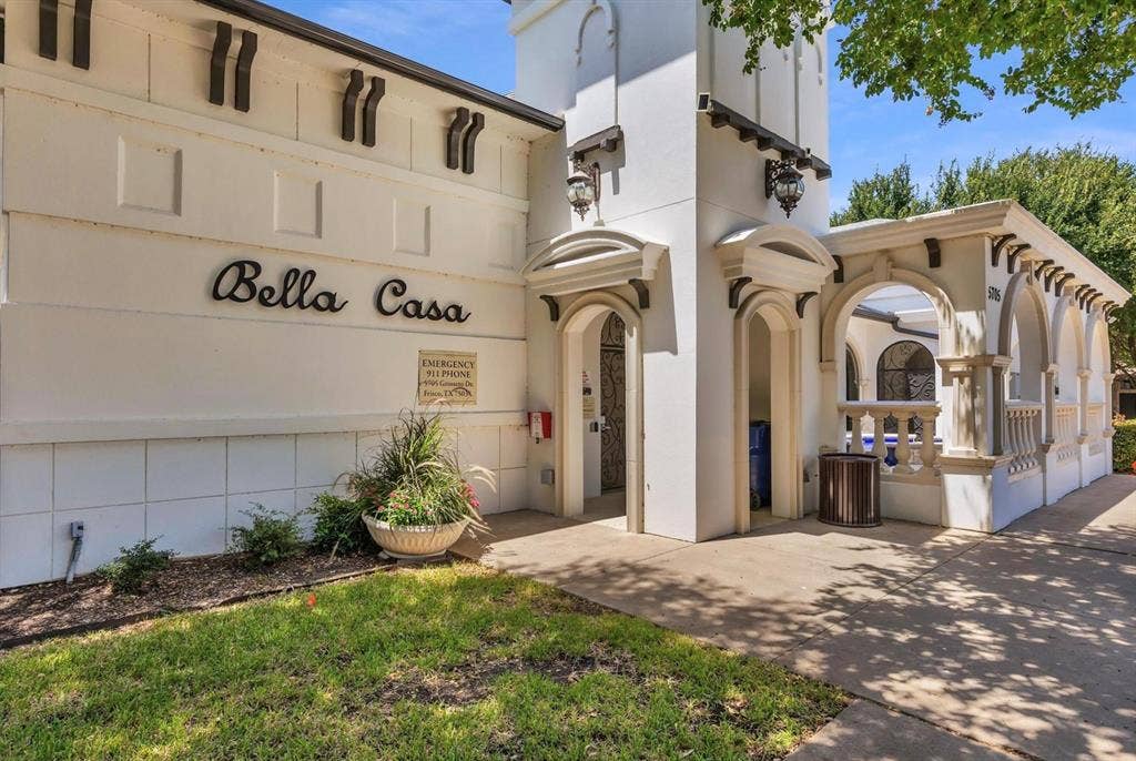 6816 Livorno Lane, Frisco, TX 75034 Spanish Colonial style architecture with arched doorways, decorative corbels, and exterior wall sconces
