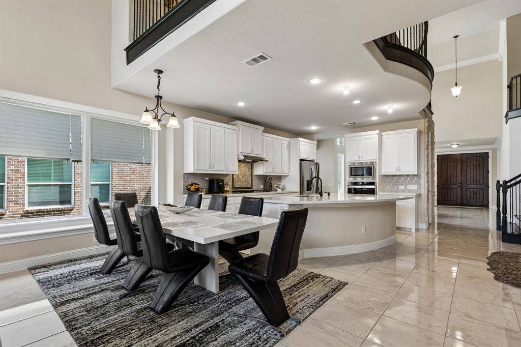 3613 Sparkling Drive, Plano, TX 75074 Two-story foyer with wood-finish double doors, tile flooring, and a chandelier
