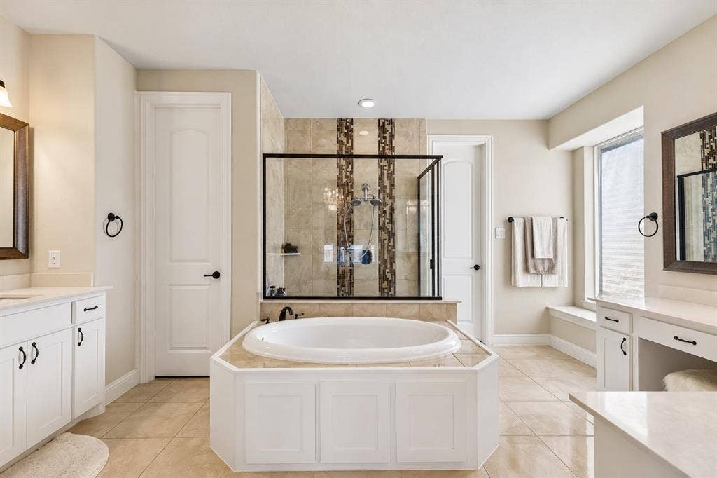 3613 Sparkling Drive, Plano, TX 75074 Built-in soaking tub, framed glass shower, dual vanity, tile flooring, and integrated window seating