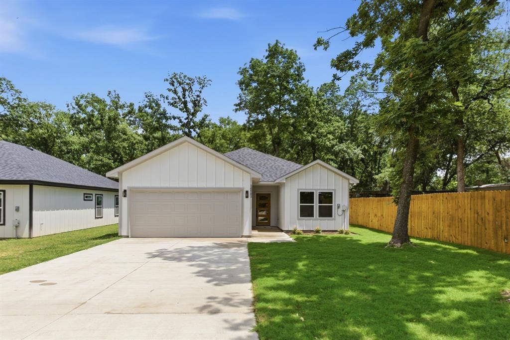14583 Cherokee Lane, Log Cabin, TX 75148 Contemporary exterior with white board and batten siding, dark shingle roof, and a concrete driveway