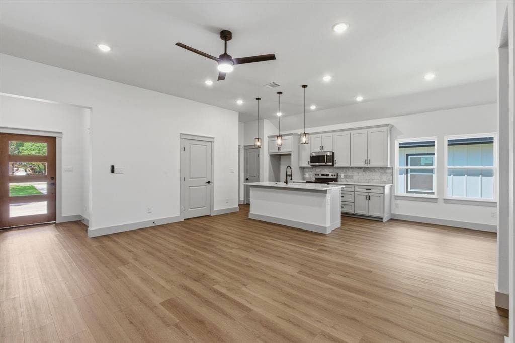 14583 Cherokee Lane, Log Cabin, TX 75148 Open-concept living area with wood-finish flooring, recessed lighting, and a contemporary ceiling fan