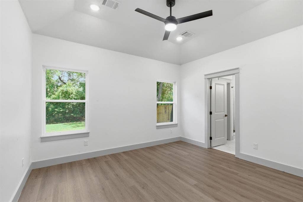14583 Cherokee Lane, Log Cabin, TX 75148 Vaulted ceiling, two windows, wood-finish flooring, modern ceiling fan, recessed lighting