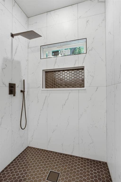 14583 Cherokee Lane, Log Cabin, TX 75148 Shower stall featuring white marble-look wall tiles, a rainfall showerhead, and a coordinating handheld shower