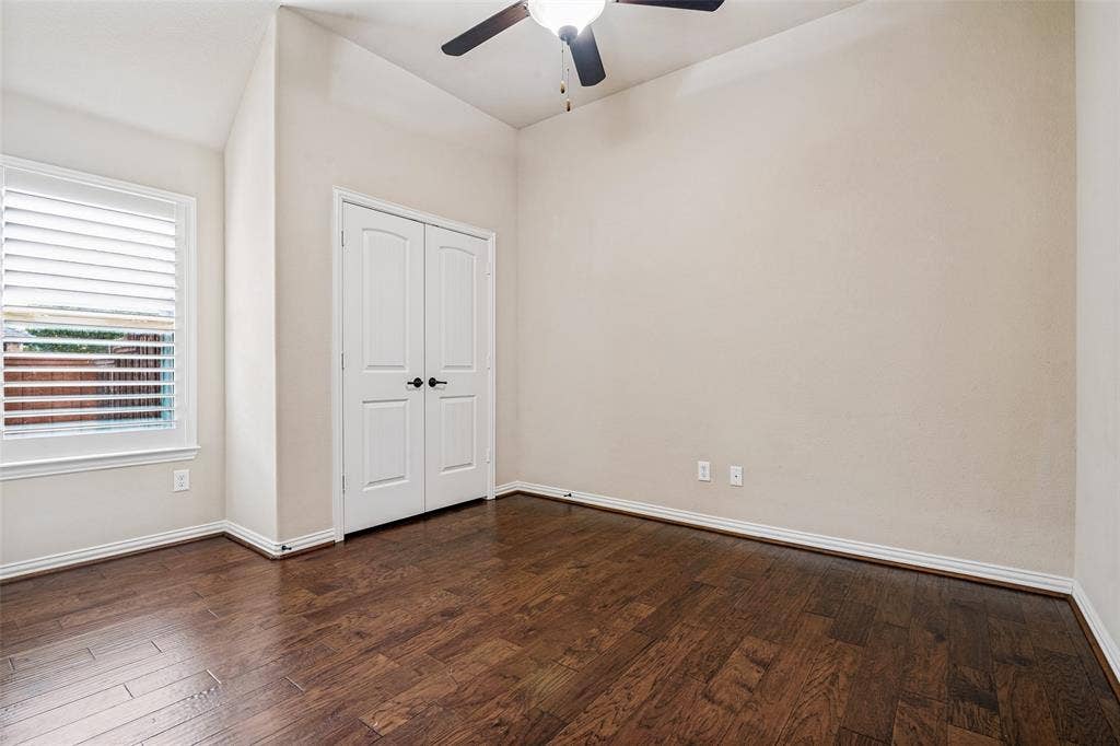 Guest BR 1 with wood floors and ceiling fan