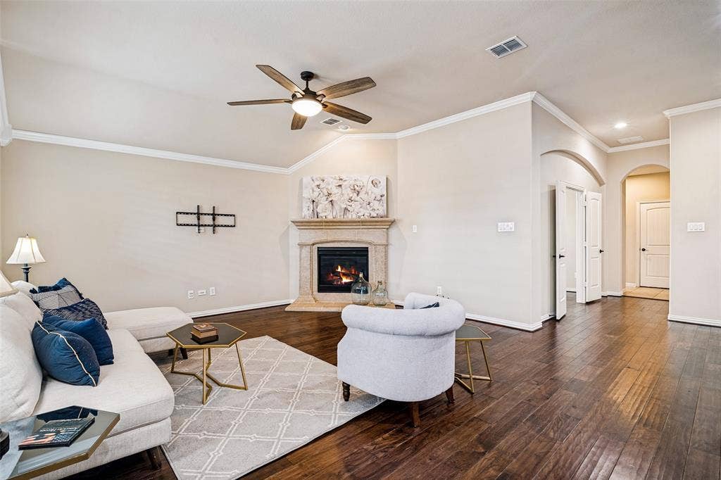 living room with gas fireplace overlooks back yard