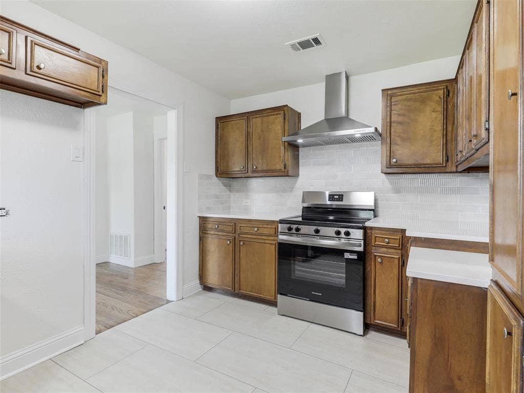 1502 Resistol Road, Garland, TX 75042 Custom cabinetry and a 5 burner range.