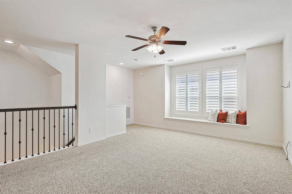 Wall-to-wall carpeting, ceiling fan with integrated lighting, recessed lighting, window seating, and plantation shutters