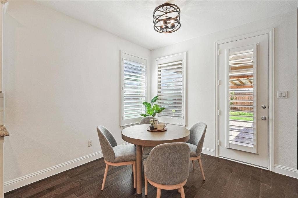Wood-finish flooring with white baseboards