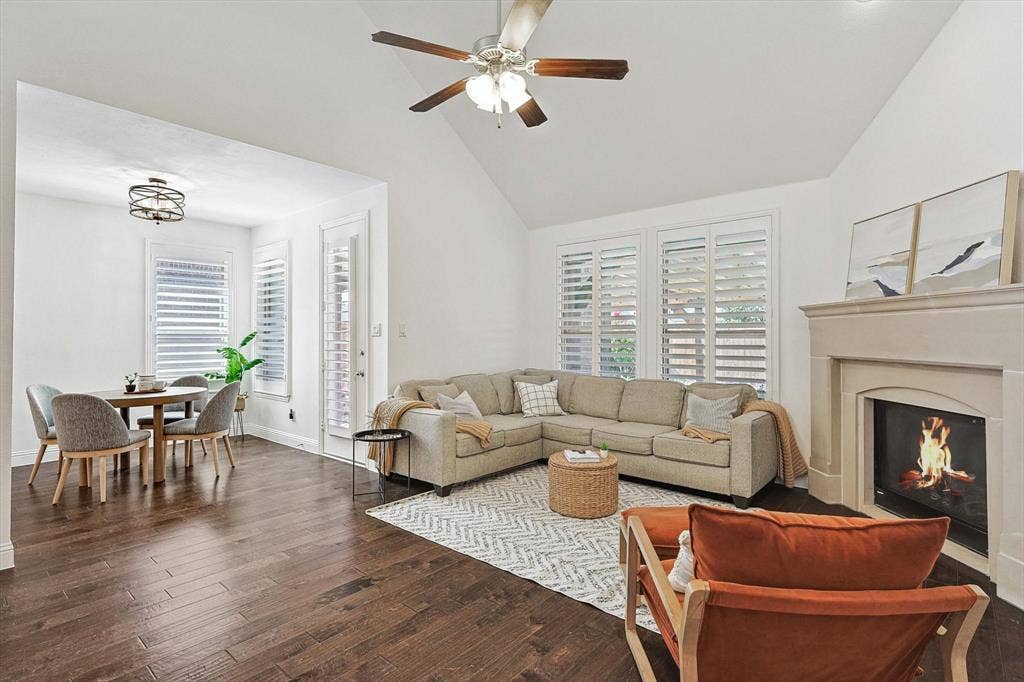 Wood-finish flooring throughout, complemented by a vaulted ceiling with a ceiling fan
