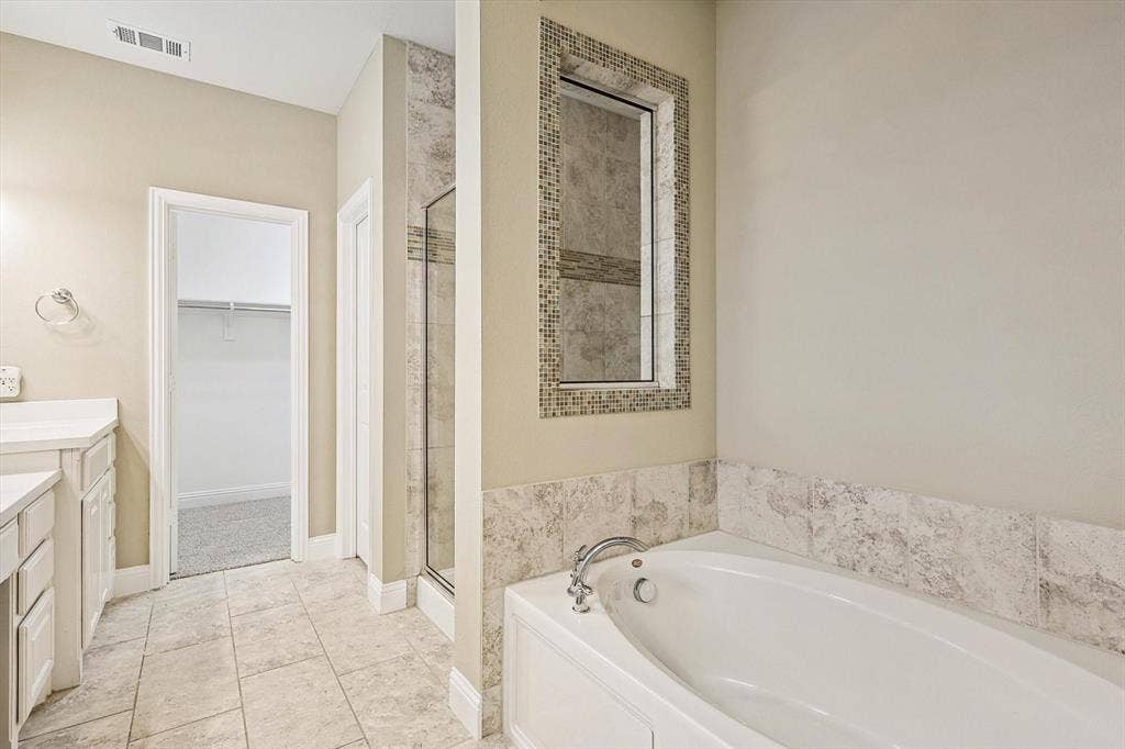 Built-in soaking tub with stone tile surround