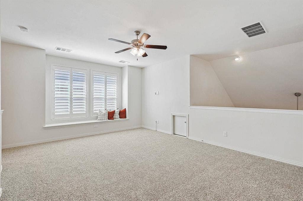 Recessed lighting, ceiling fan with light, window seat, plantation shutters, and carpeted flooring