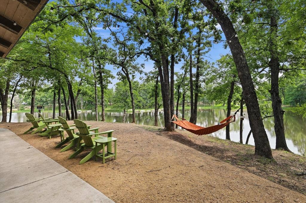 Lakeside setting with mature trees and a concrete patio