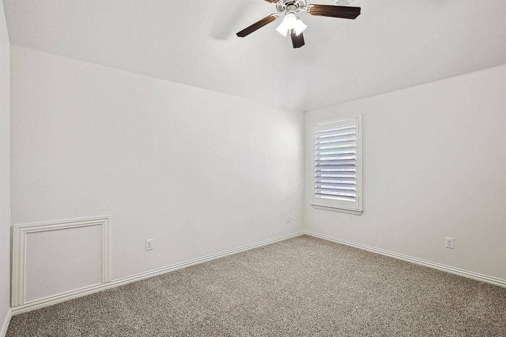 Recessed lighting fixture with a ceiling fan, carpeted flooring, and a single window with louvered shutters