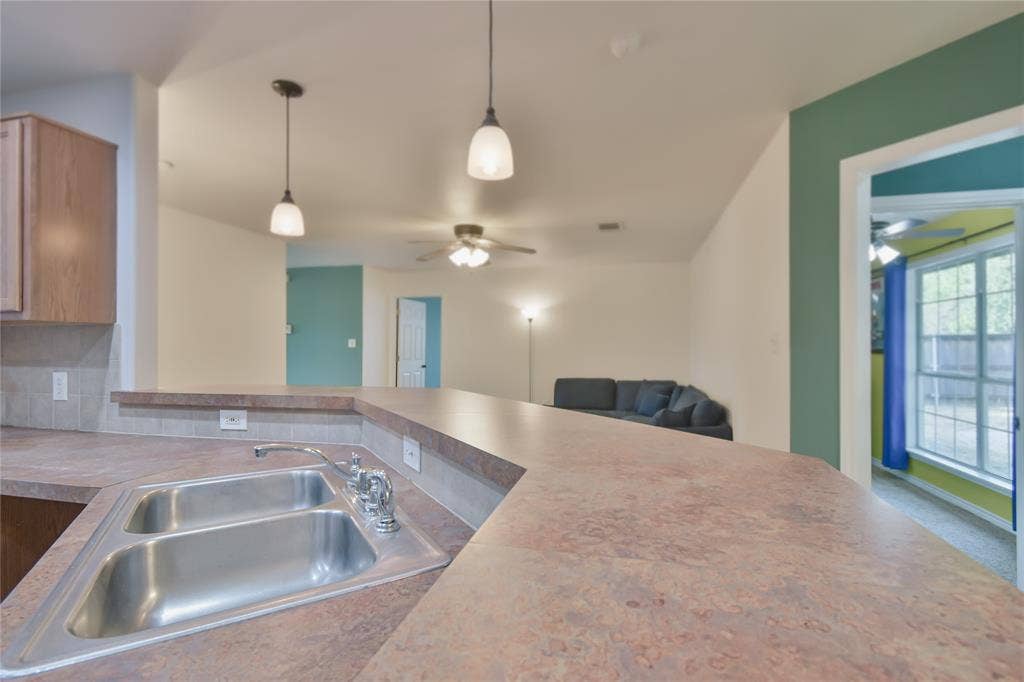 2108 8th Street, Brownwood, TX 76801 Dual-basin stainless steel sink with a chrome faucet, set into a composite countertop