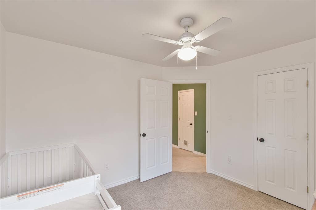 2108 8th Street, Brownwood, TX 76801 Light-colored carpeting, white walls, and a ceiling fan with integrated lighting