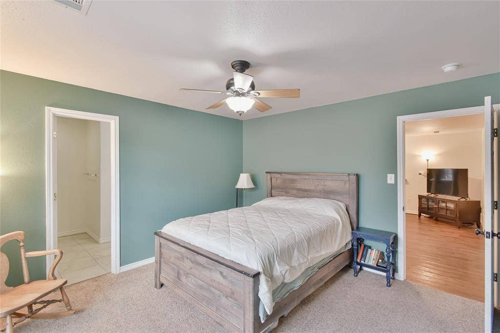 2108 8th Street, Brownwood, TX 76801 Carpeted bedroom featuring a ceiling fan with integrated lighting