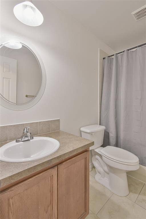 2108 8th Street, Brownwood, TX 76801 Vanity with integrated sink, tile flooring, and a full shower/tub combination