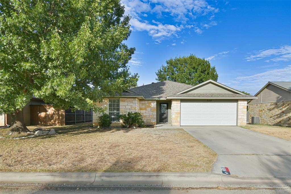 2108 8th Street, Brownwood, TX 76801 Stone veneer exterior with a gabled roofline