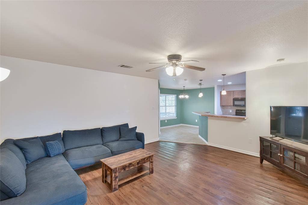2108 8th Street, Brownwood, TX 76801 Expansive living area with wood-finish flooring, a ceiling fan, and recessed lighting