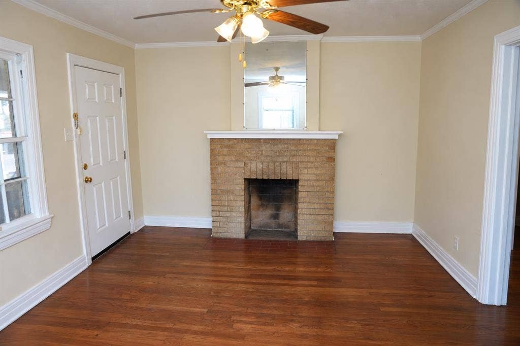 5108 Manett Street, Dallas, TX 75206 Hardwood floors, original fireplace, and abundant natural light in vacant front unit.