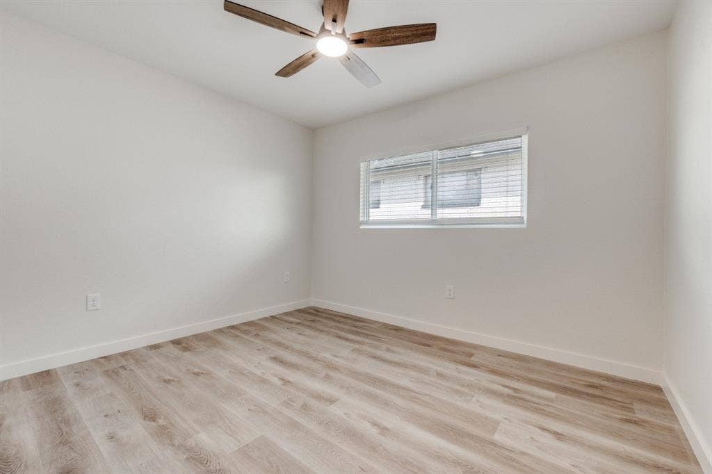 5917 Gaston Avenue, #115, Dallas, TX 75214 Wood-finish flooring with white walls and a ceiling fan