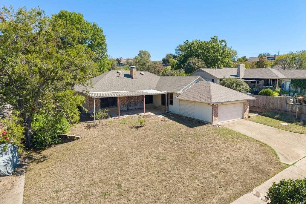 Brick veneer exterior with a covered patio and attached garage