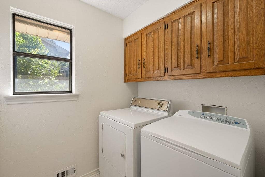 White walls featuring a single window with dark framing and custom blinds