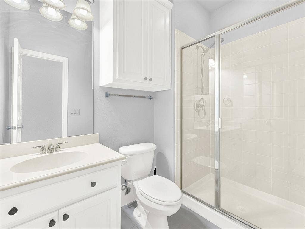 10222 Plainsman Lane, Frisco, TX 75035 White vanity with an integrated sink, polished chrome faucet, and storage cabinetry