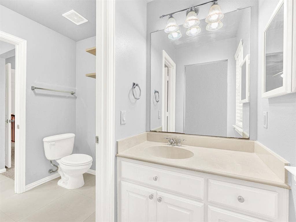 10222 Plainsman Lane, Frisco, TX 75035 White vanity with an integrated sink and light-toned countertop