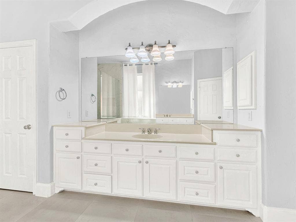 10222 Plainsman Lane, Frisco, TX 75035 Expansive vanity featuring a single basin sink, white cabinetry, and light-toned countertop