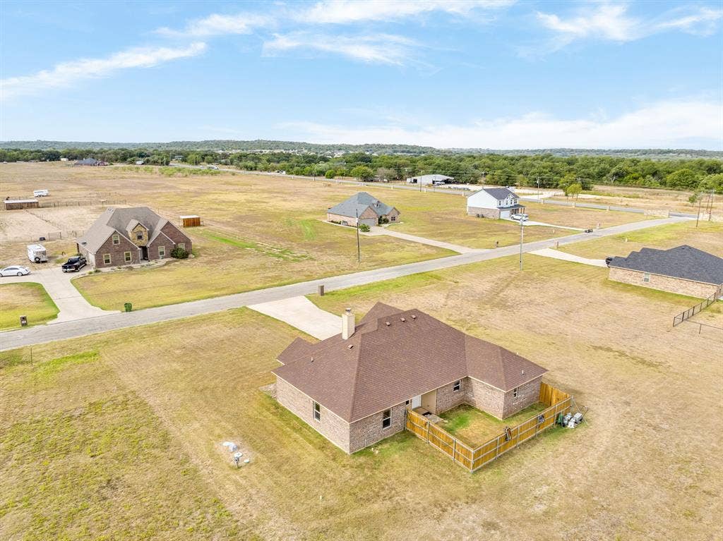 1215 River Hills Road, Stephenville, TX 76401 Drone view of home and fenced backyard