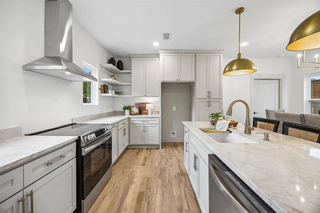 The stainless steel appliances include a dishwasher, electric range and commercial grade vent