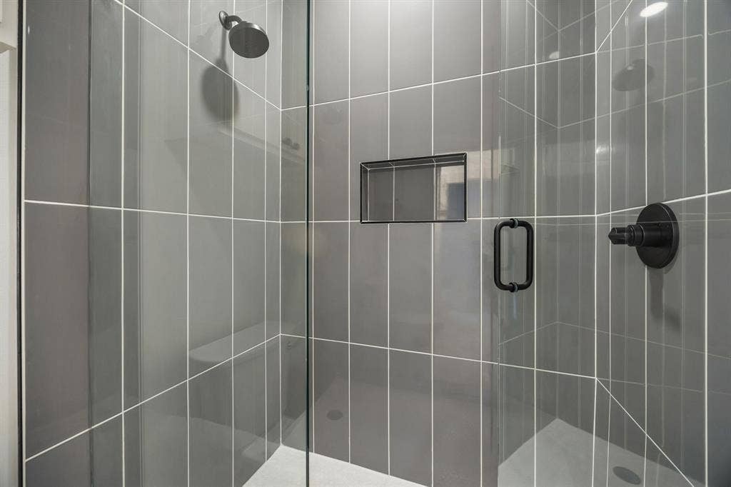 Frameless glass shower in the jack and jill bathroom
