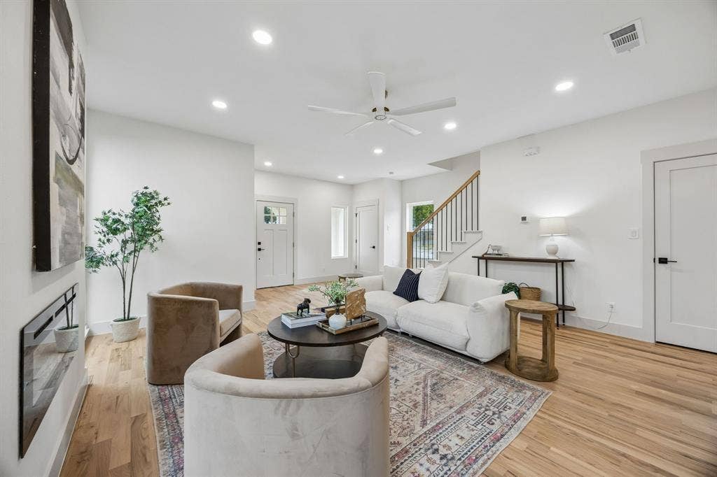 Recessed lighting, wood-finish flooring, a built-in electric fireplace, and a ceiling fan with light