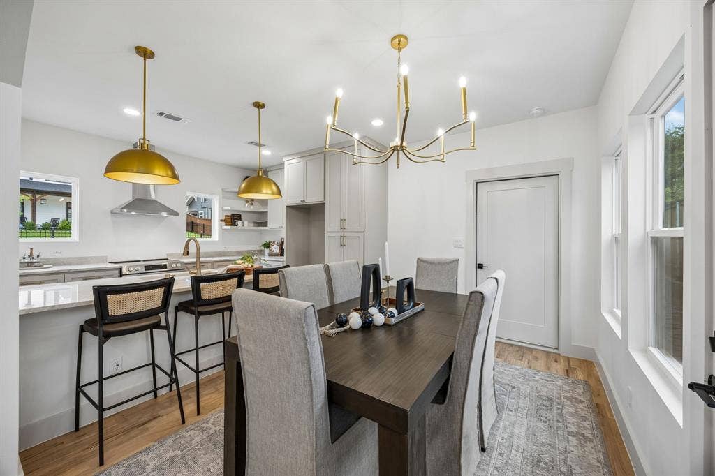Open-concept kitchen and dining area featuring modern lighting.