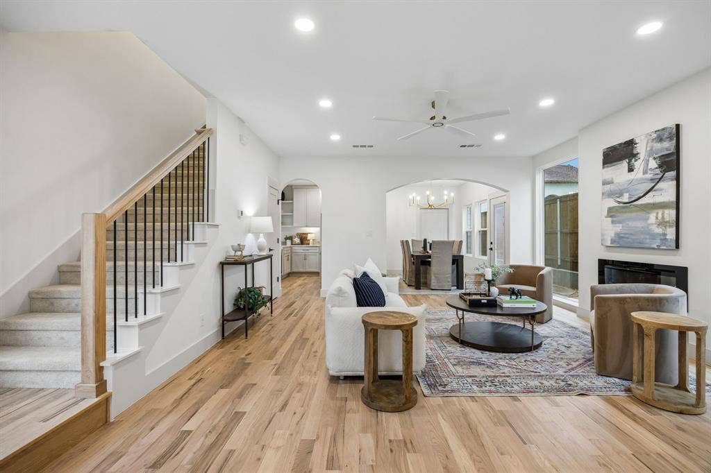 Wood-finish flooring throughout the living area, recessed lighting, ceiling fan and an electric fireplace