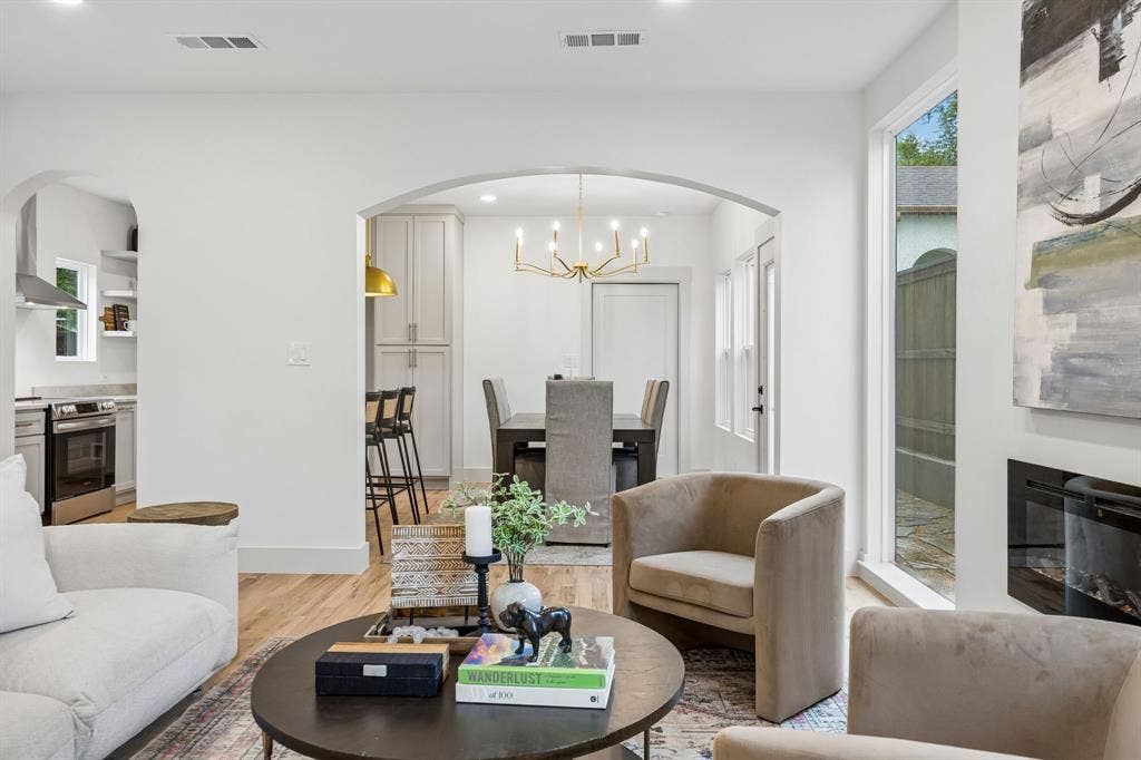 Open-concept living area looking into the eat in kitchen