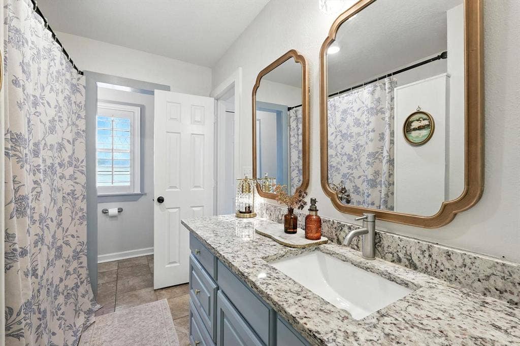 185 Quail Run Court, Decatur, TX 76234 Dual vanity with granite countertop, integrated rectangular sink, and brushed nickel faucet