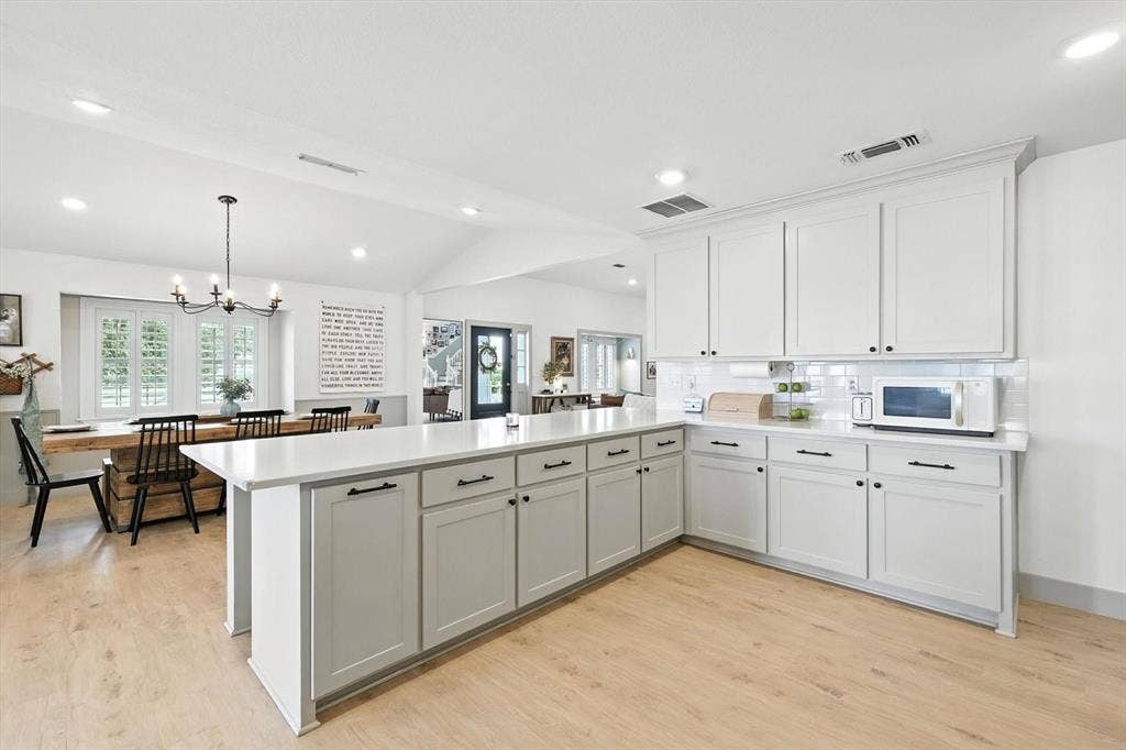 185 Quail Run Court, Decatur, TX 76234 Spacious kitchen featuring white shaker-style cabinetry, light countertops, and a white subway tile backsplash