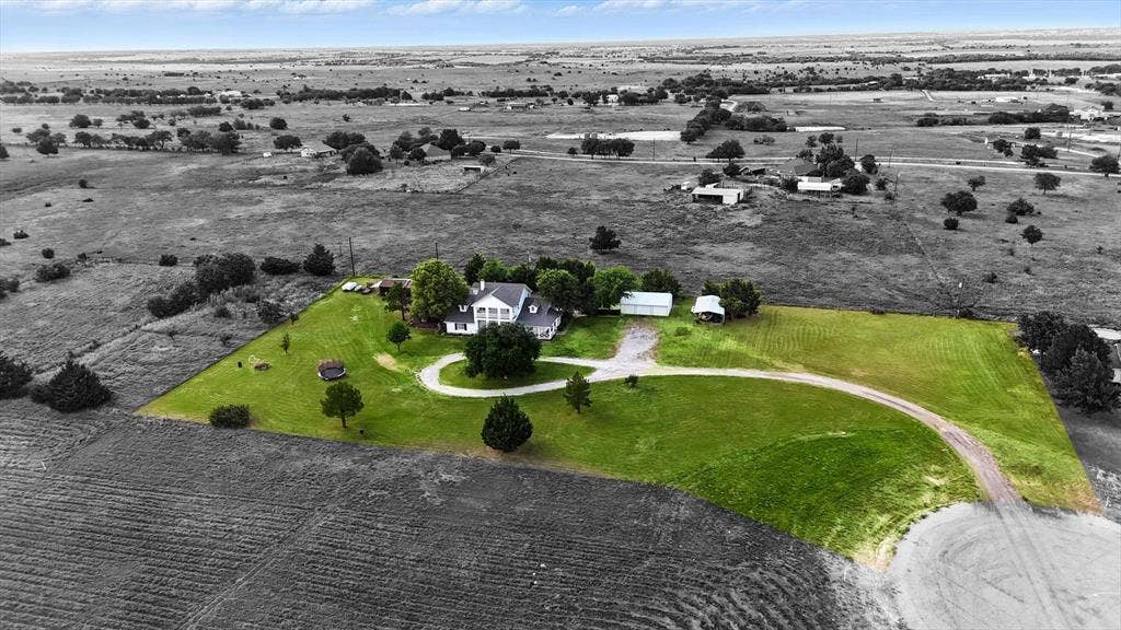 185 Quail Run Court, Decatur, TX 76234 Expansive property featuring a circular driveway, mature trees, manicured lawns, and outbuildings