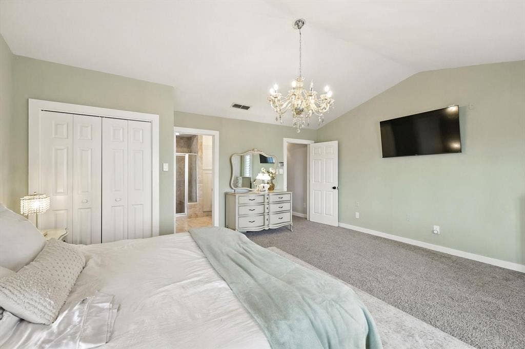185 Quail Run Court, Decatur, TX 76234 Vaulted ceiling, crystal chandelier, and neutral wall paint
