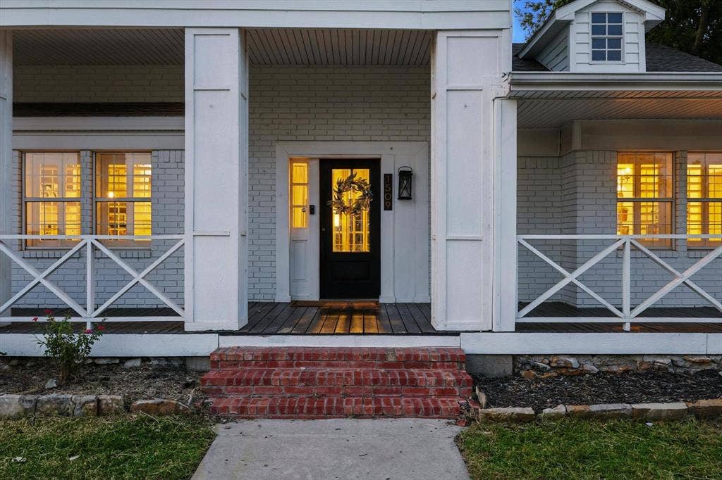 185 Quail Run Court, Decatur, TX 76234 Brick exterior with white trim, covered front porch, wood-finish porch flooring, and brick steps