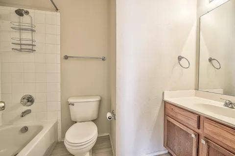 White tiled shower and bathtub combination