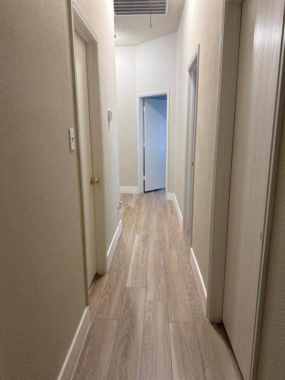 Wood-finish flooring throughout the hallway