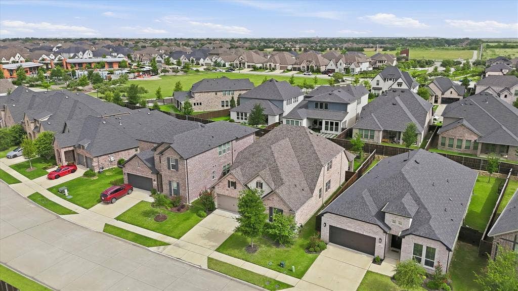 2637 Basswood Drive, Northlake, TX 76226 Expansive neighborhood featuring multiple single-family homes with brick and stone exteriors, manicured lawns, and attached garages
