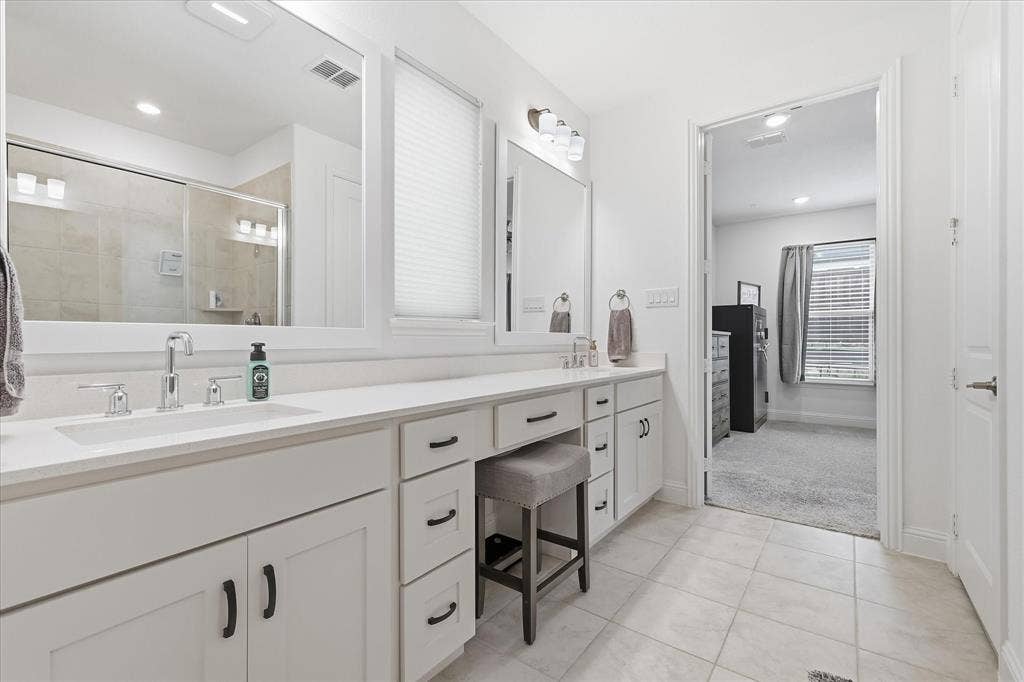2637 Basswood Drive, Northlake, TX 76226 Dual vanity with white cabinetry and dark hardware, integrated sinks, and ample counter space