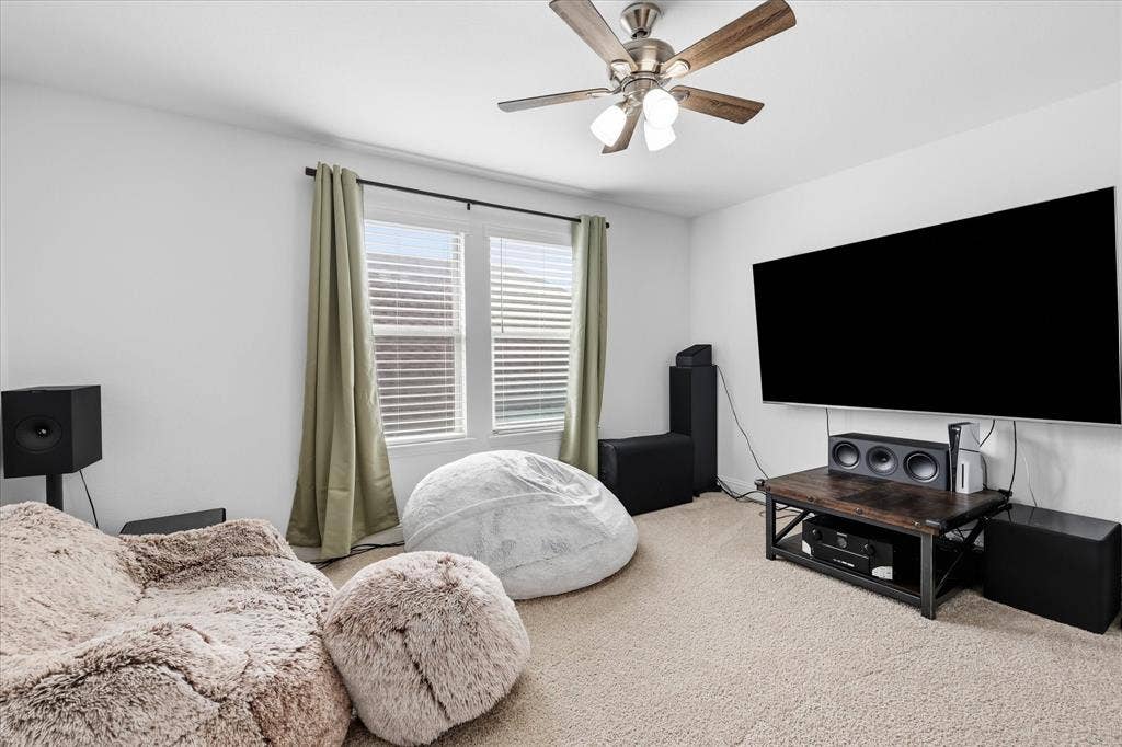 2637 Basswood Drive, Northlake, TX 76226 Carpeted flooring, window with blinds and drapes, ceiling fan, and wall-mounted television