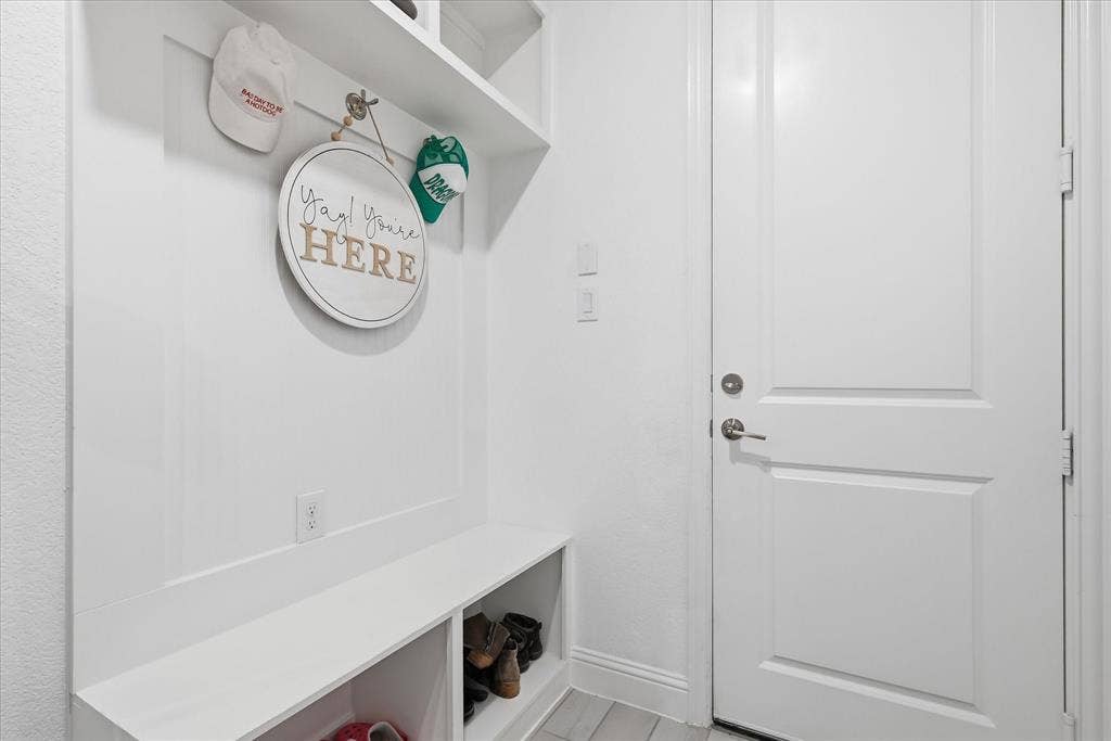 2637 Basswood Drive, Northlake, TX 76226 Built-in bench with integrated shelving, overhead shelf, wall paneling, and a solid core door
