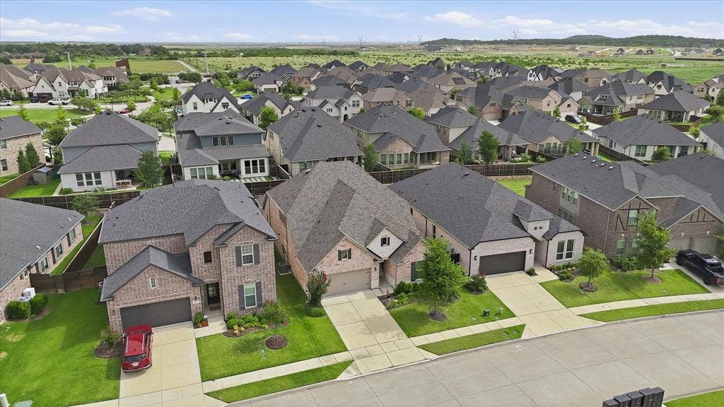 2637 Basswood Drive, Northlake, TX 76226 Residential neighborhood featuring multiple single-family homes with brick and siding exteriors, attached garages, and paved driveways