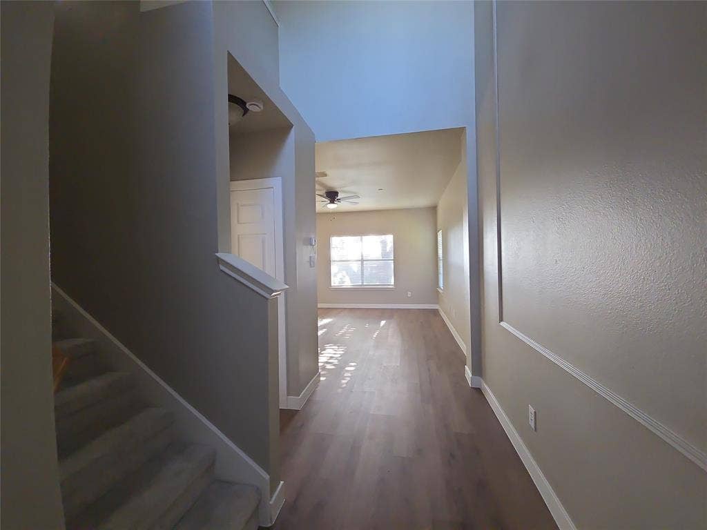 8621 Brunswick Drive, Plano, TX 75024 Vaulted ceilings, wood-finish flooring, carpeted staircase, ceiling fan, and recessed lighting